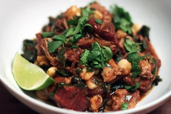Melissa Clark’s Spicy Pork Stew with Hominy and Collard Greens
