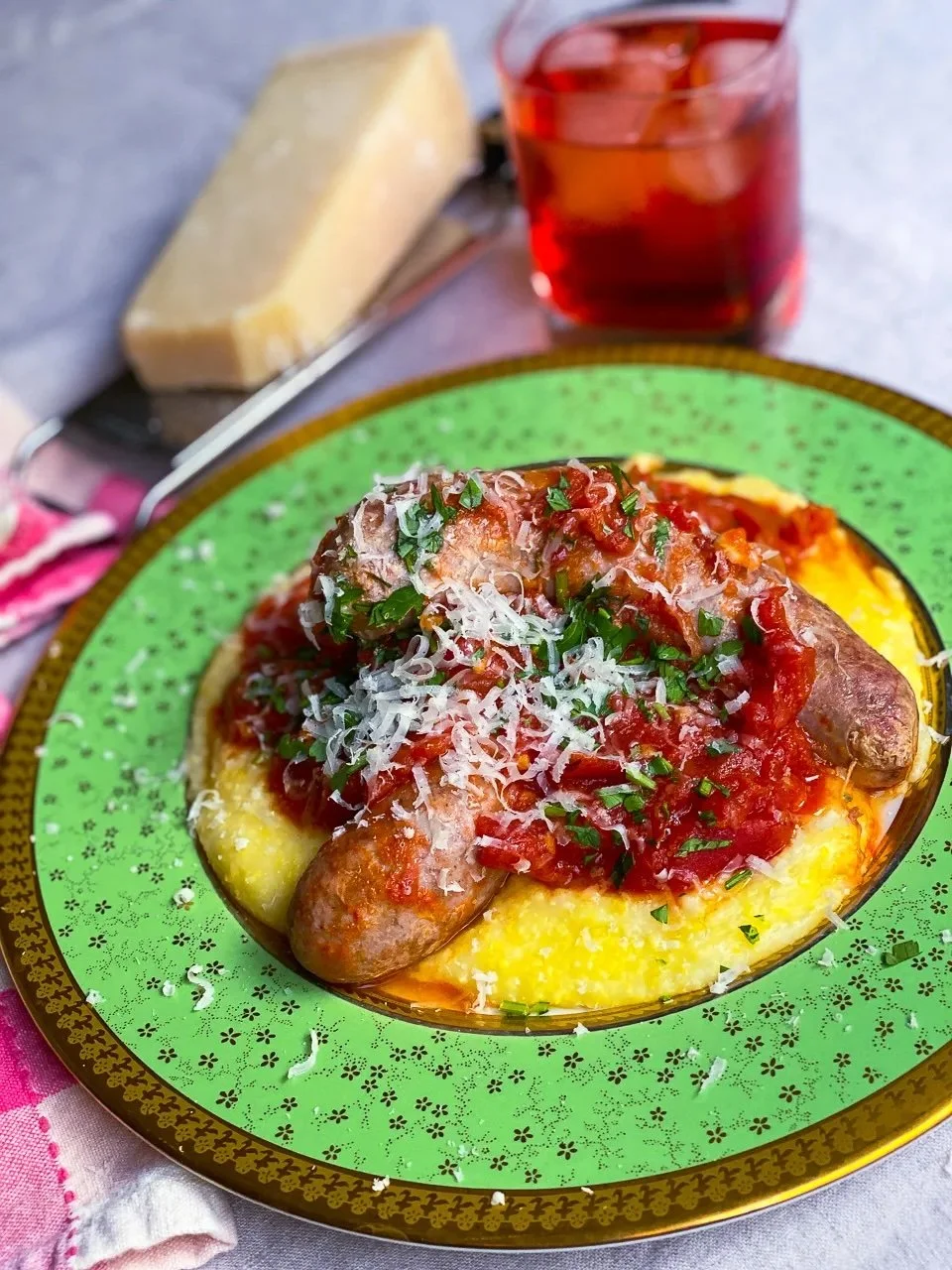 Sausages Braised in Tomato Sauce Over Polenta