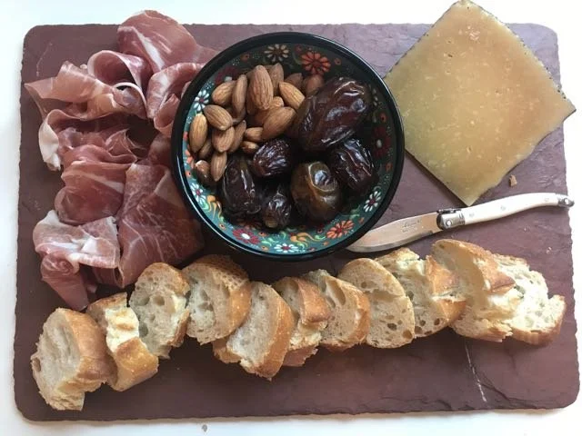 Iβm really into making cheese plates lately. My trick is to create levels with little bowls filled with stuff (dates, nuts). Oh that cheese is Manchego. Also: Iβm experimenting with captions.