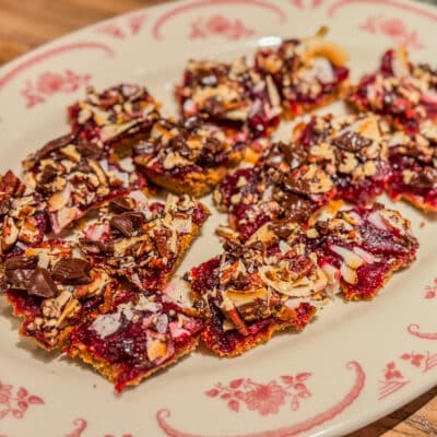 A plate of cranberry magic bars with coconut, pecans, and chocolate.