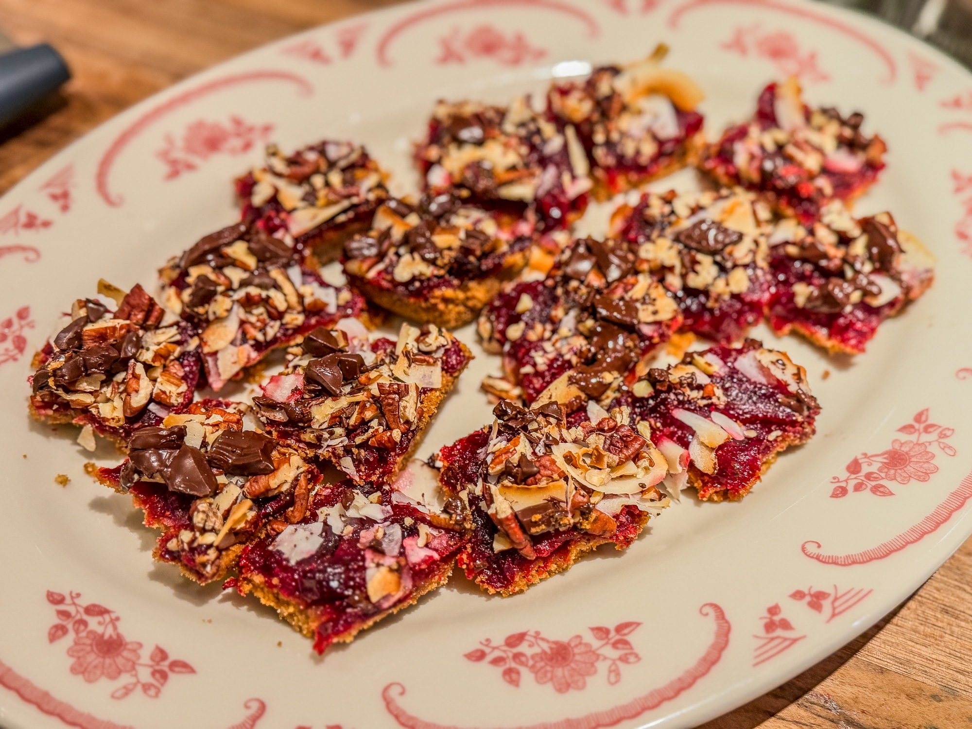 A plate of cranberry magic bars with coconut, pecans, and chocolate.