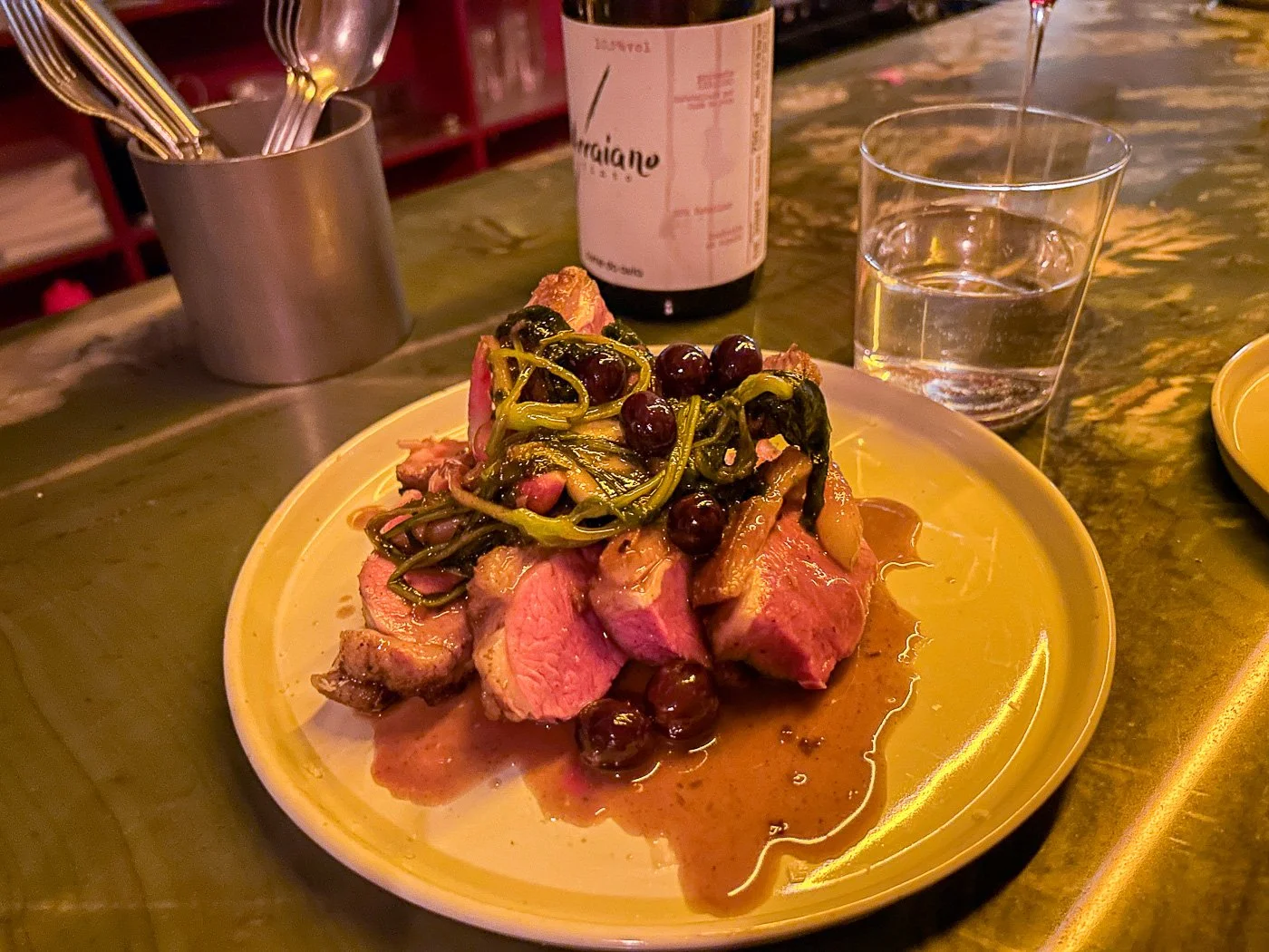  While this was a more traditional restaurant dish, it was still pretty extraordinary. The combination of tart fruit and perfectly rare duck with some kind of greenery and sauce hit all the right spots. The presentation — which you can see above — was both homey and arty, that perfect sweet spot of modern dining.   For dessert, there was no way I wasn’t getting the famous $22 slice of chocolate cake which  Helen Rosner in  The New Yorker   described as: “a wedge of darkness, six layers of night-black devil’s-food cake alternating with strata of an intense and creamy ganache.”  